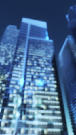 blurred night cityscape with illuminated skyscrapers