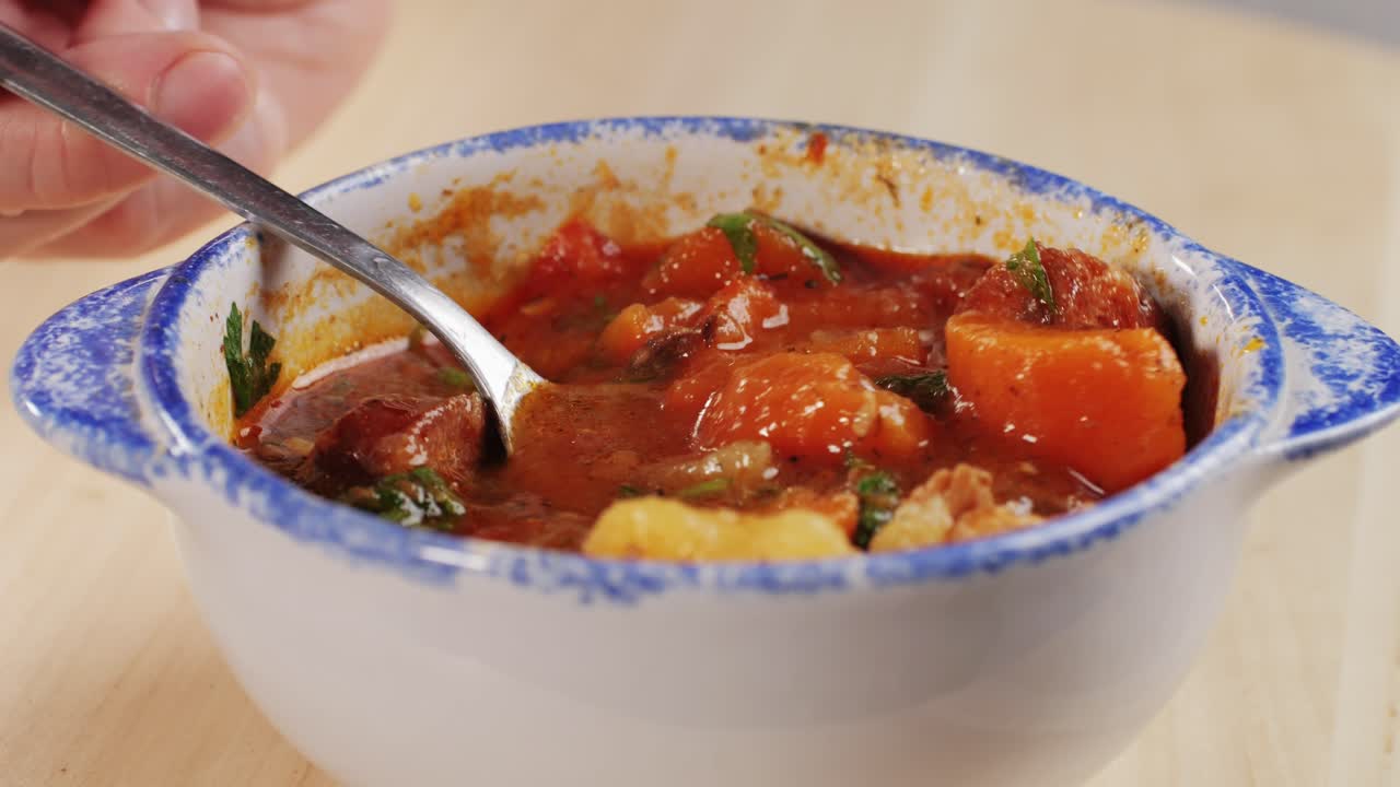 Goulash soup with potato, carrot, meat and bolgarian papper and parsley cilantro in top. Shurpa soup. High quality 4k footage