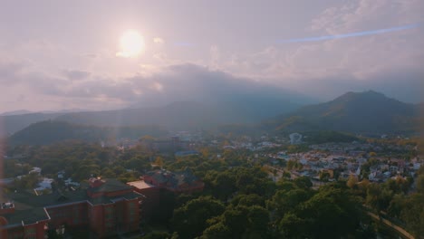 aerial view of a town with mountains and sunset