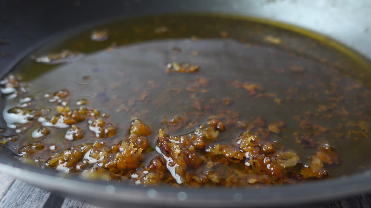 Cooking Oil with Pieces in a Pan