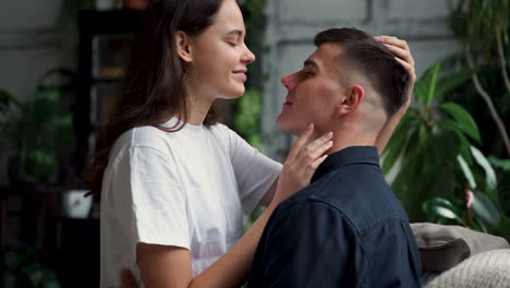 young happy woman and man cuddling and caressing each other