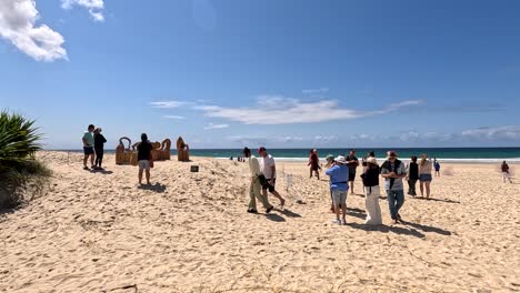 beach scene with sculptures and people