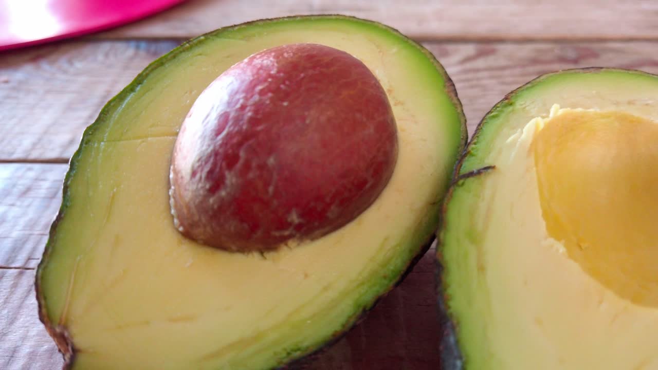 Fresh avocado halves on a wooden table in centro Cuernavaca, bright morning vibe
