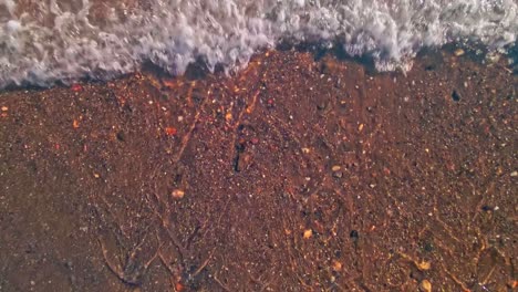 close up of ocean waves, drone moving up into the sky