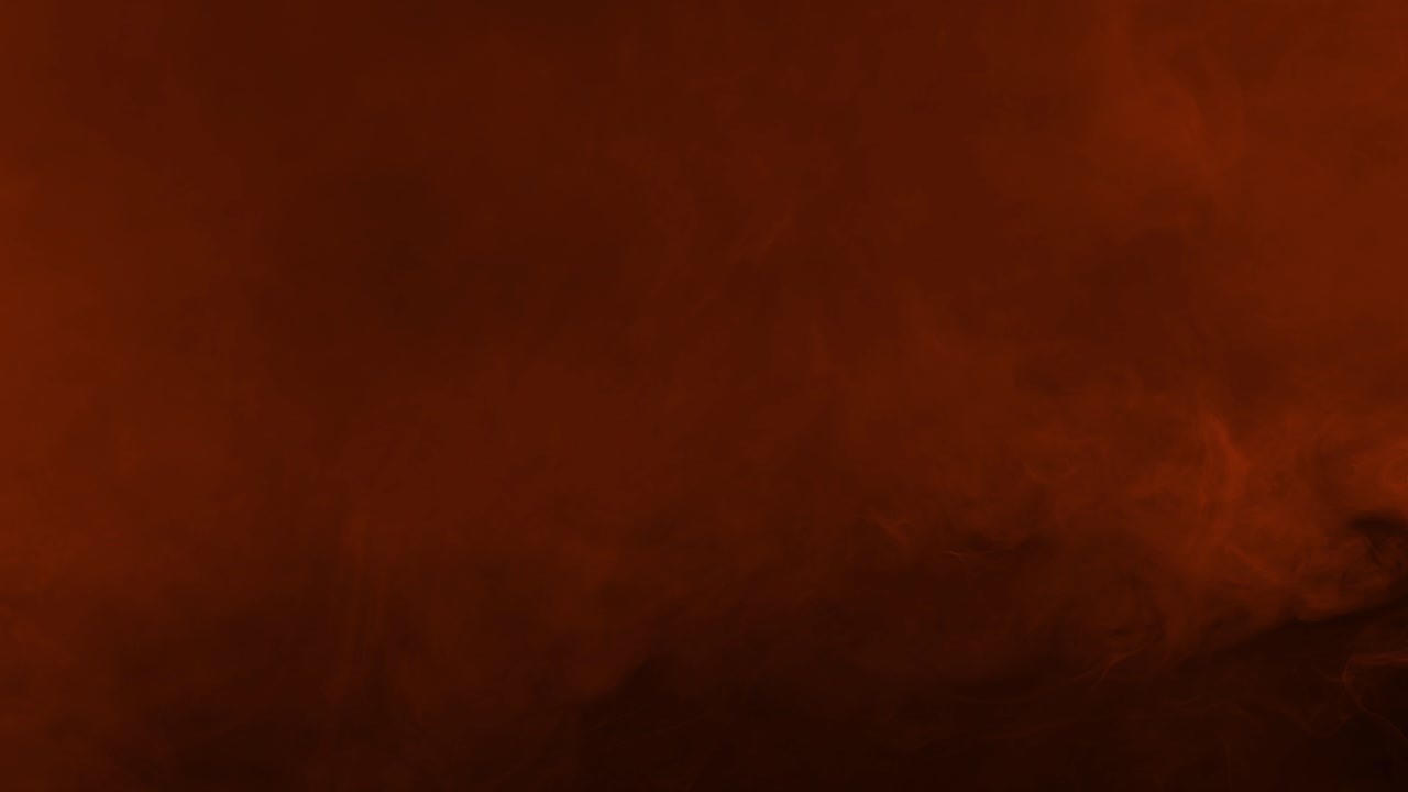 Nebbia e fumo color ambra arancione che creano una trama densa su sfondo nero, in loop continuo.