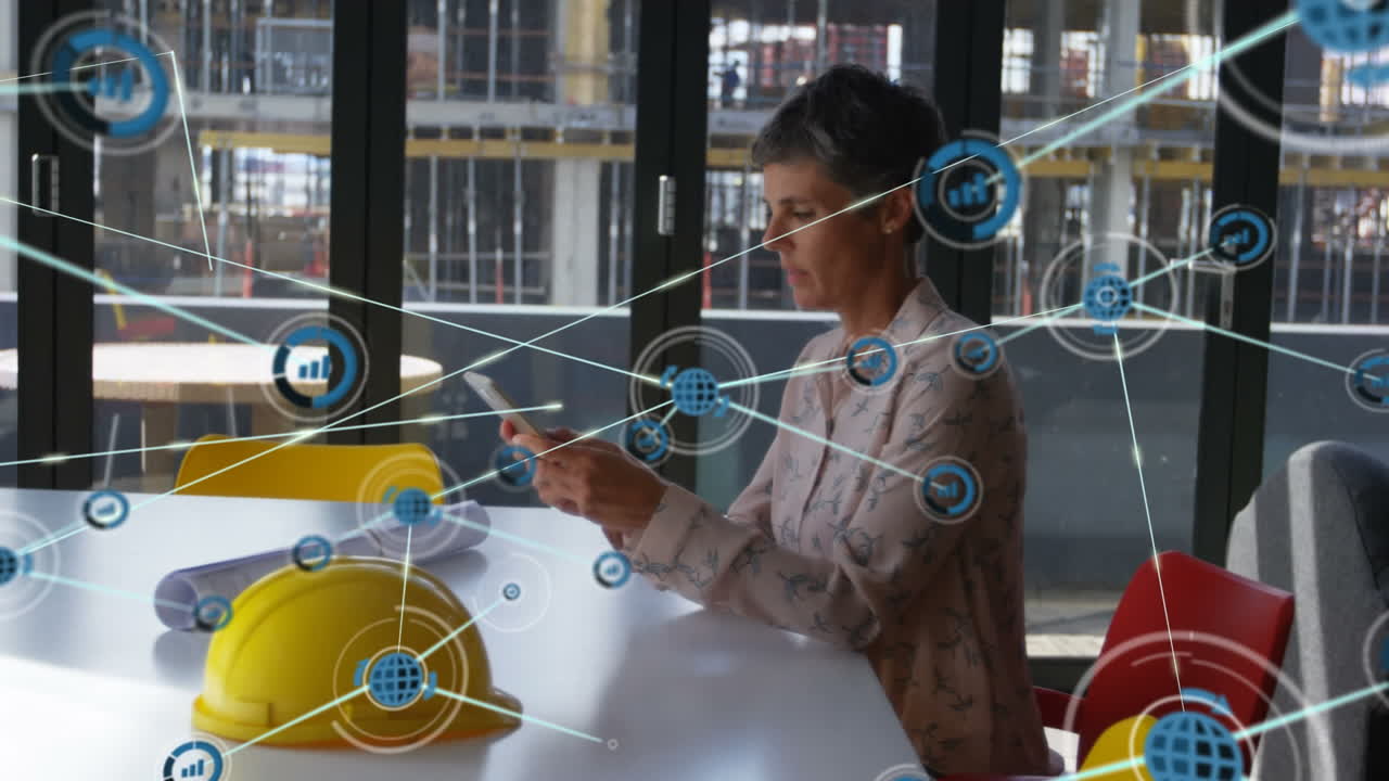 animación de una red de conexiones con iconos sobre una arquitecta caucásica usando una tableta