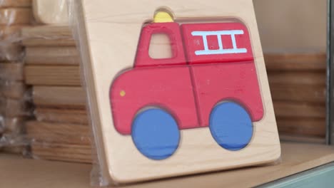 small handmade wooden puzzle of a red fire truck for toddlers