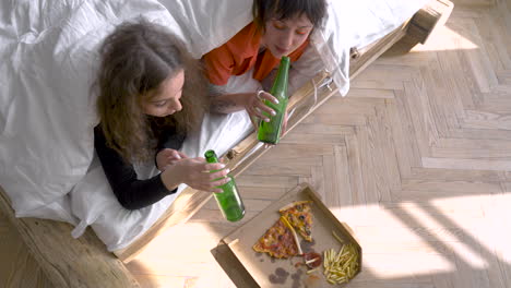 top view of girls drinking beers and talking