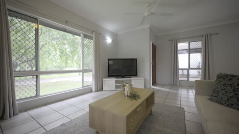 interior desing of a contemporary living room with big windows and white walls