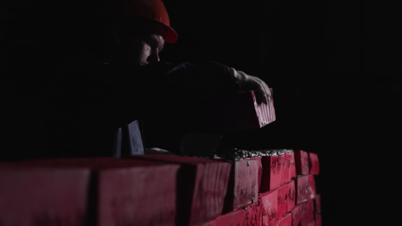 Construction Worker Laying Bricks at Night