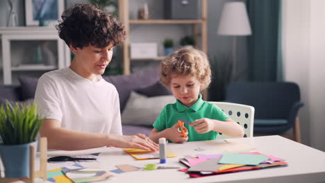 mother and son doing paper crafts together