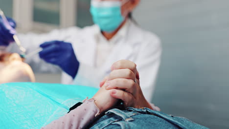 dentist comforting patient during examination