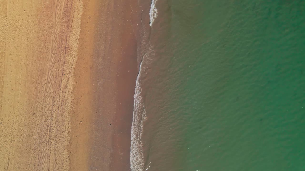 Vista aerea di onde calme sulla spiaggia.