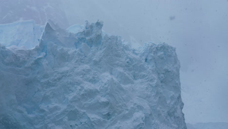 Glacier-Ice-on-Snowy-Misty-Day,-Coast-of-Antarctica,-Close-Up