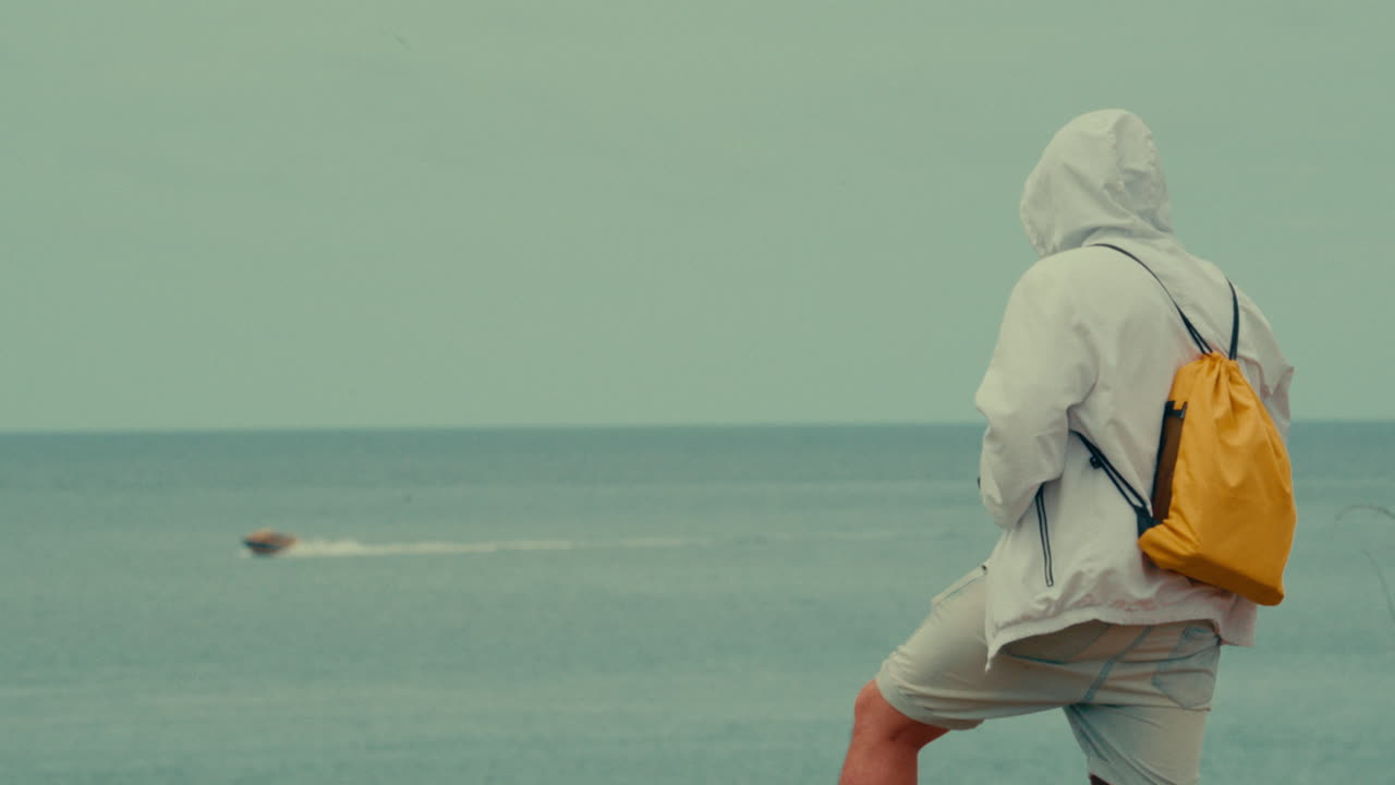 Man on the beach looking out at the ocean
