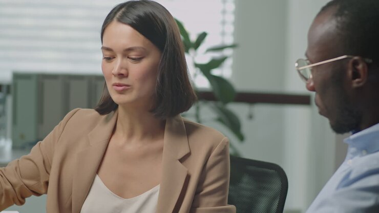 Businesswoman Having Discussion with Colleague in Office