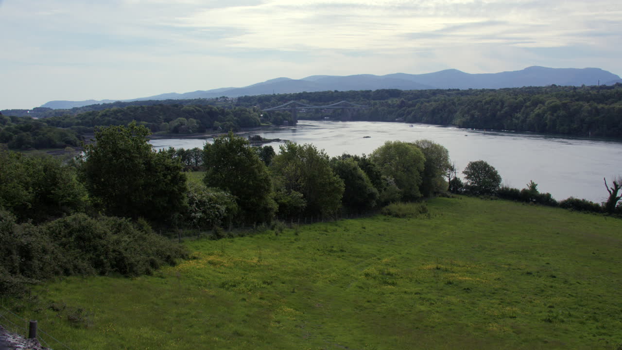 Extra wide shot of the Menai Strait with Menai Suspension Bridge in background at Llanfairpwllgwyngyll
