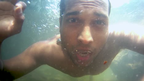 man swimming at river flowing underwater clip from low angle