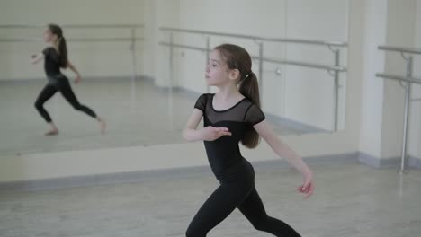 young ballet girl at studio lesson. training performance. stretching exercise pose. ballerina practice balance technique. classical elegance fitness.