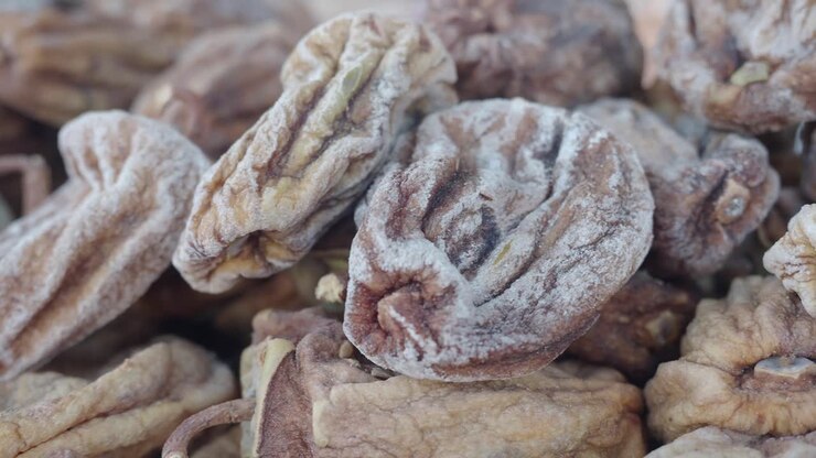 A close-up shot of a pile of dried persimmons