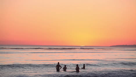 La-Gente-Se-Reúne-En-El-Océano-Al-Atardecer