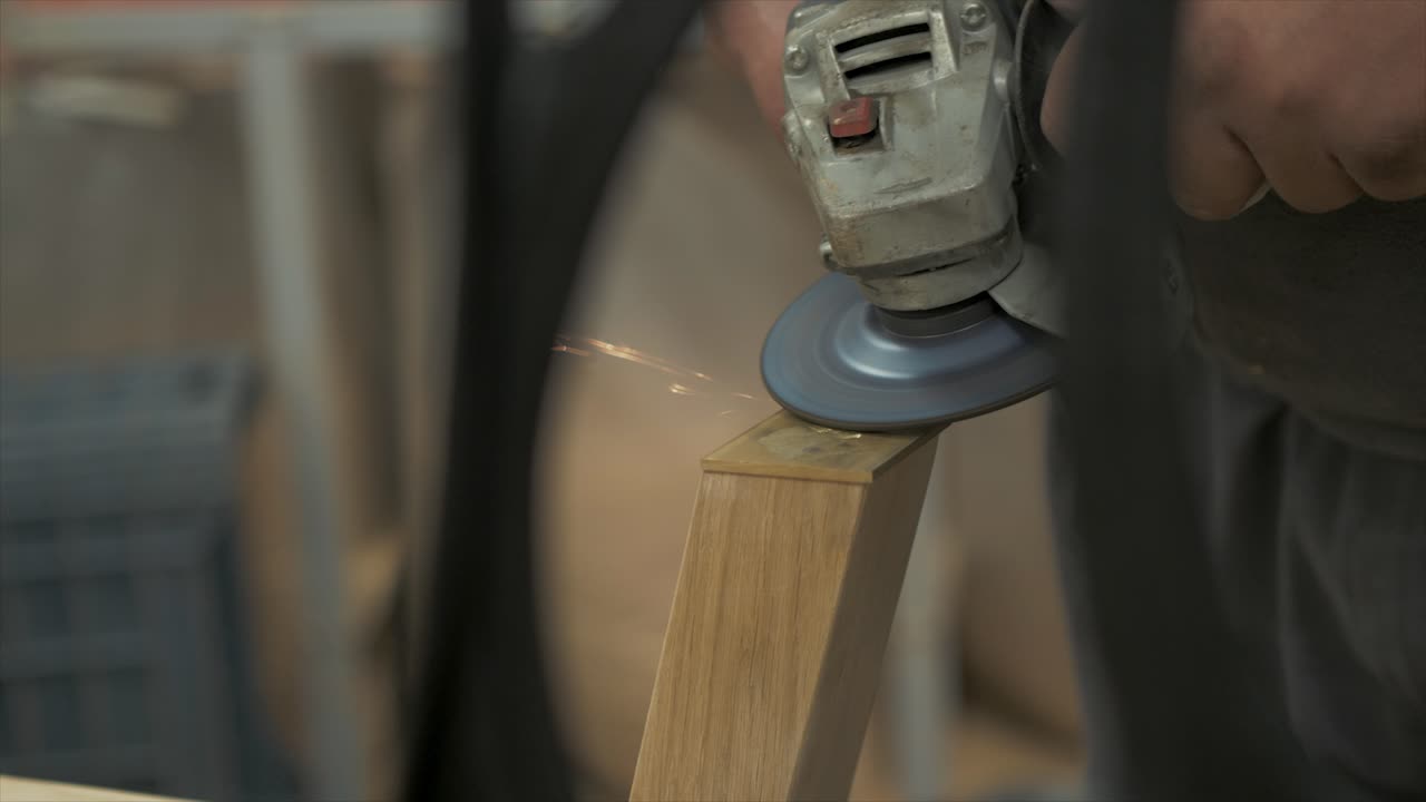 Sparks flying angle grinding metal plate Rack focus close up shot