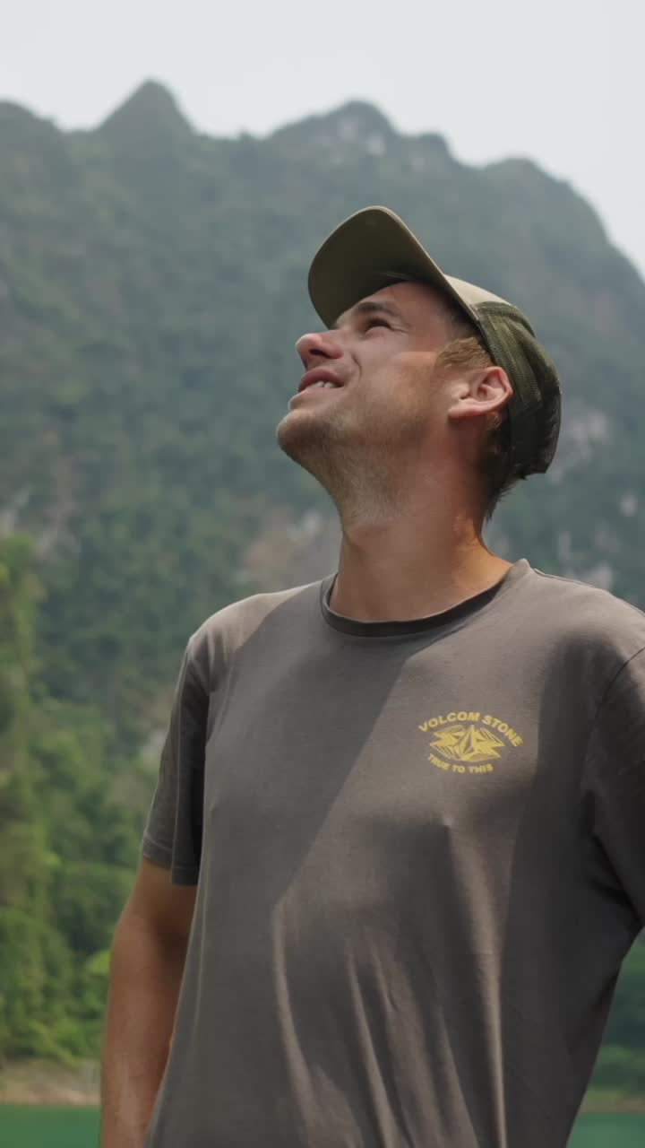 Man looking up at mountains