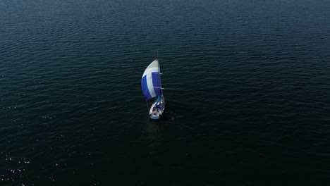 Sailboat-gracefully-glides-on-the-Baltic-Sea-with-a-colorful-sail,-evoking-tranquility-and-peacefulness