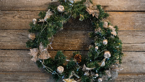 animation of snow falling over wreath and christmas decoration