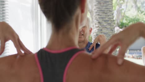 adultos mayores diversos que tienen clase de pilates con una entrenadora, sin alteración, en cámara lenta
