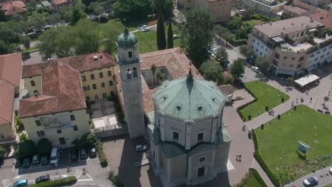 Beautiful-drone-view-of-a-church-in-the-center-of-Riva-Del-Garda,-a-small-city-in-the-region-of-Trentino-in-North-Italy,-Point-of-Interest-Aerial-View