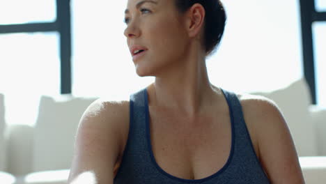 looking thoughtful, woman in athletic wear gazing into distance indoors