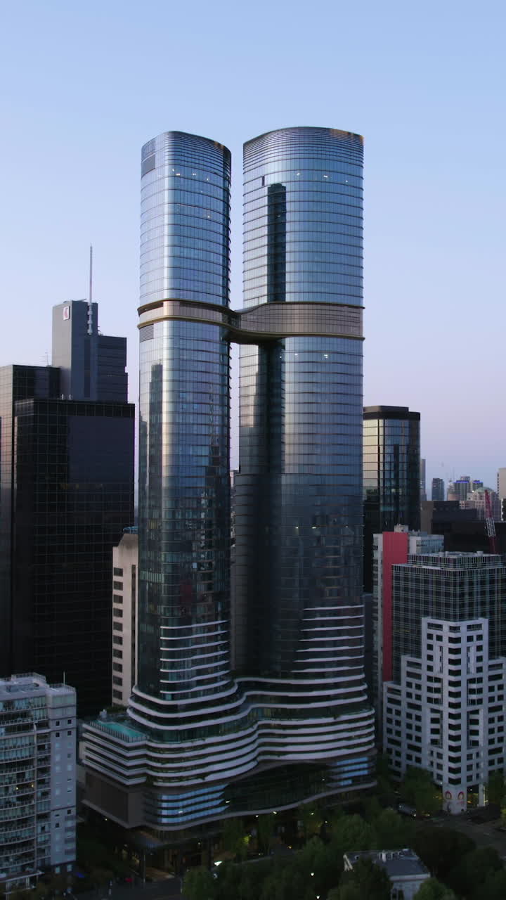 Vertical drone shot circling the Sapphire by the Gardens twin towers in Melbourne