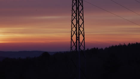 Medium-shot-of-an-electricity-pylon-at-sunrise