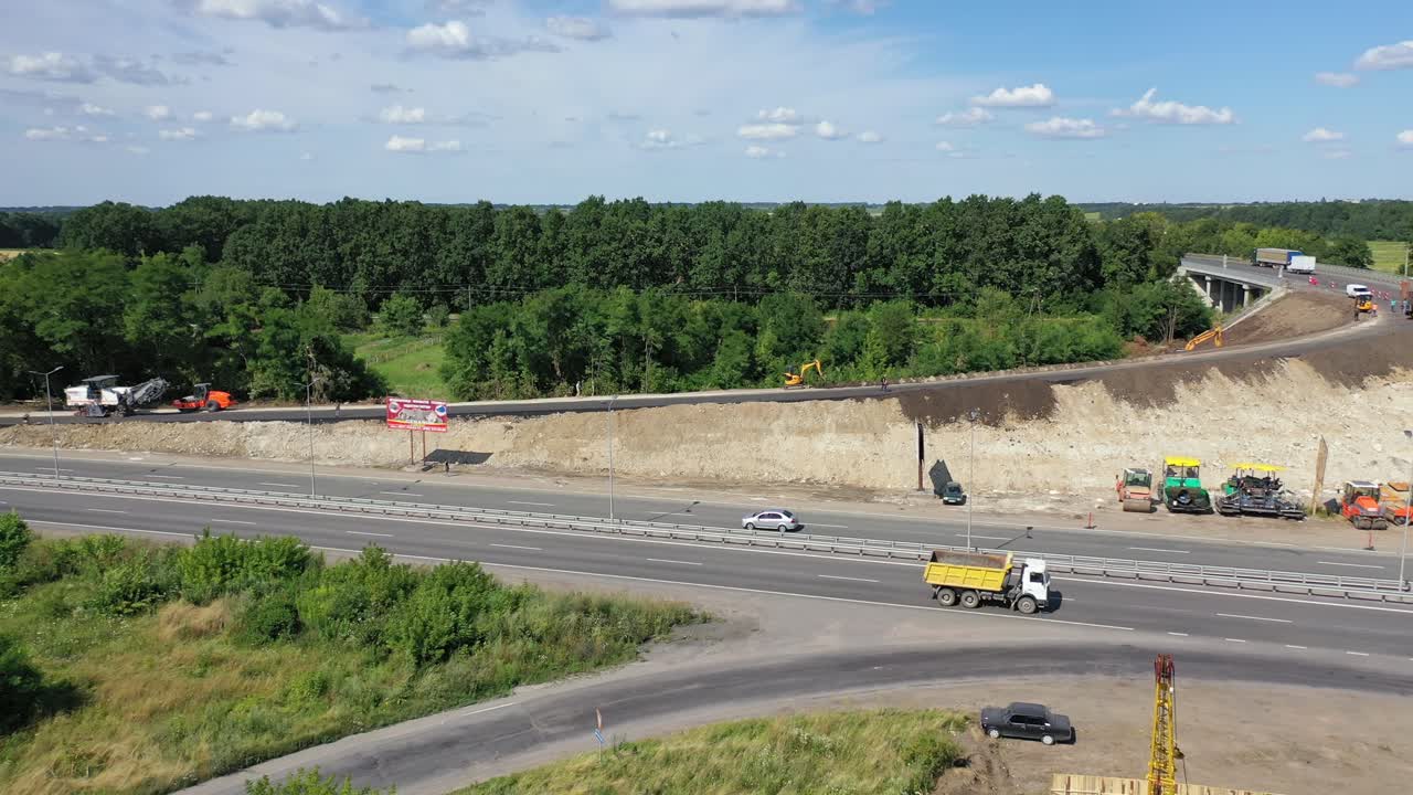 Asphalt road under construction. Aerial view aboveroad construction worker, view from drone