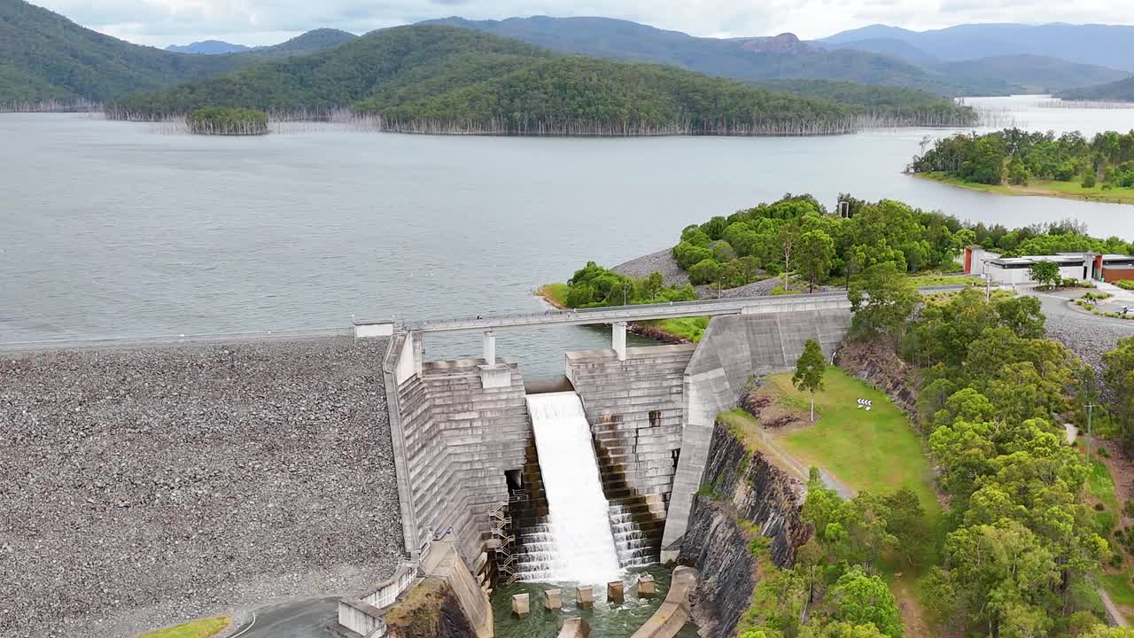 Scenic view of dam, water, and surrounding landscape
