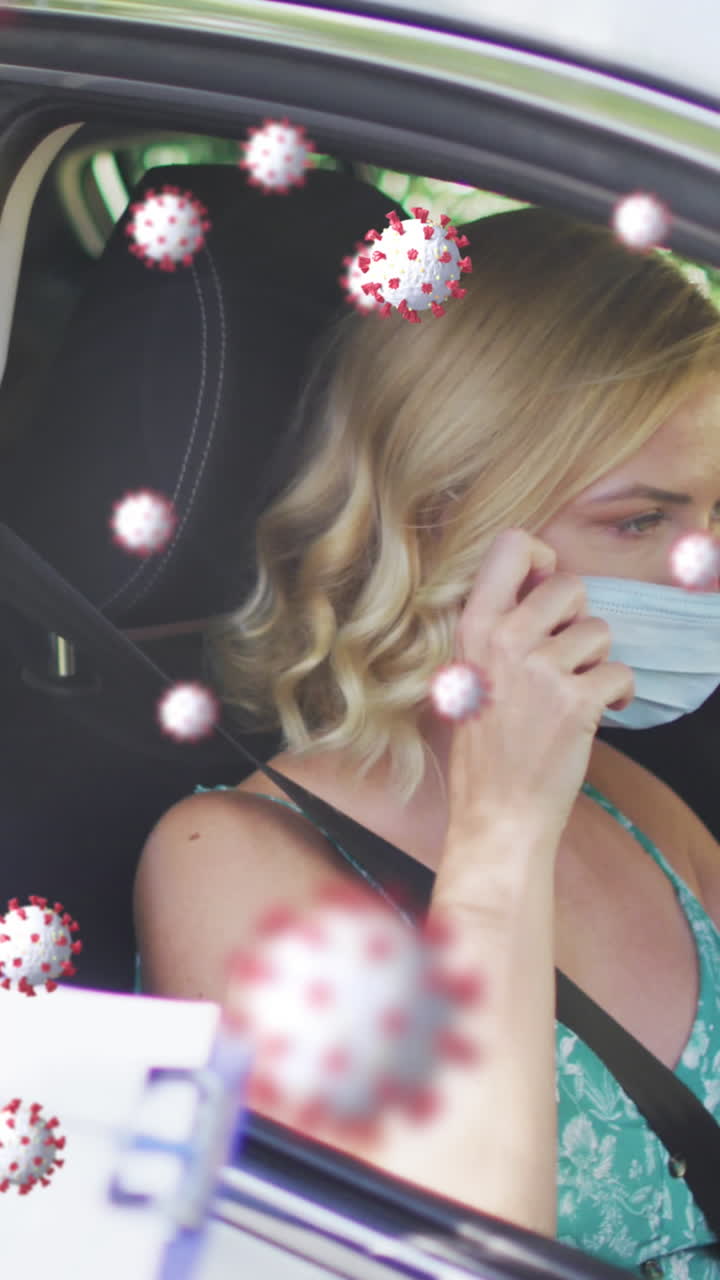 Animation of covid 19 cells over caucasian woman having swab test taken