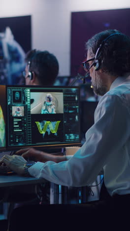 Vertical-shot-of-operators-and-flight-director-using-computers-then-applauding-and-shaking-hands-after-successful-launch-of-rocket