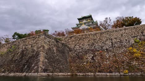 view from castle moat onto the famous osaka castle in japan