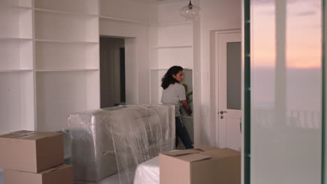 young couple moving house new home owners smiling enjoying successful move embracing in apartment