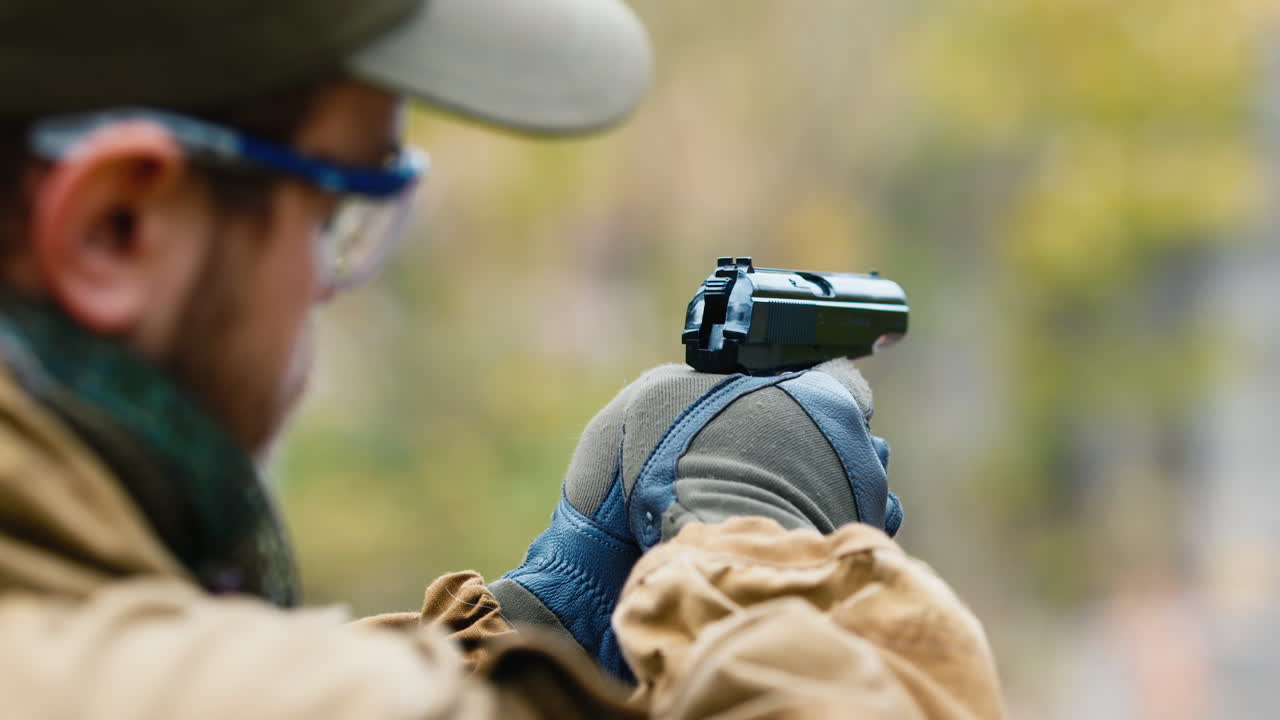 A man plays airsoft with a pistol in his hand 3