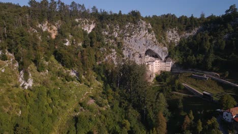 drone shot over predjama near predjama castle, connected to postojna cave