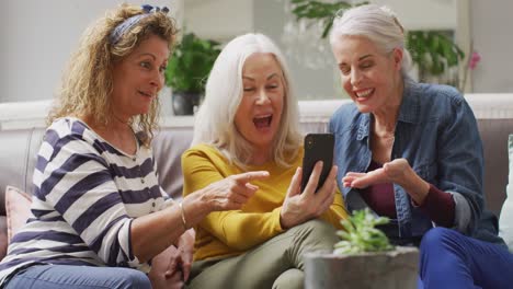 animation of happy diverse female senior friends using smartphone