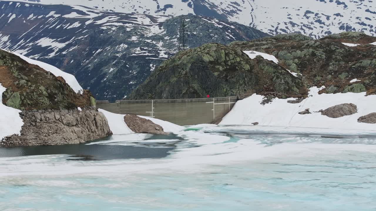 Aerial view of Totensee iced lake and dam of Grimsel Pass, Switzerland