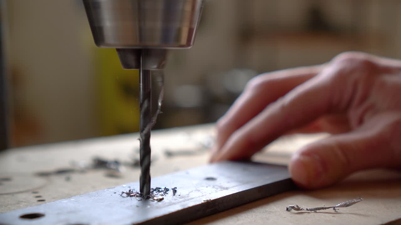 Close-up of a Drill Press Drilling into Metal