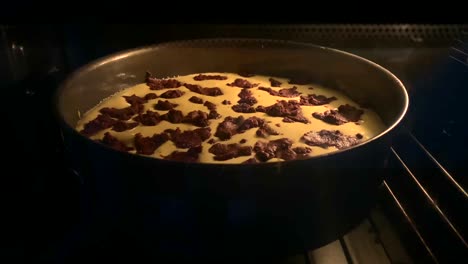 close up shot of cheesecake with chocolate baking in hot stove