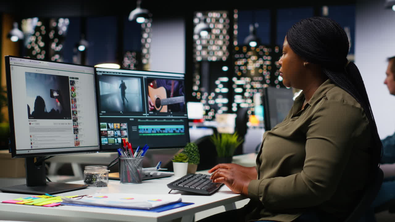 Portrait of black woman video editor working with dual monitors in agency