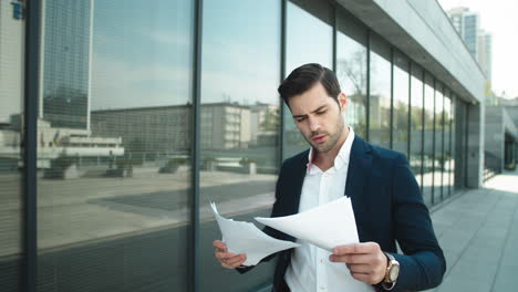 Portrait-of-businessman-walking-in-slow-motion.-Business-man-throwing-papers