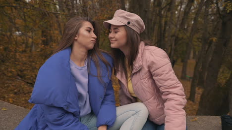 young female friends hugging outside