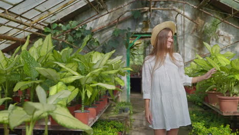 woman in a greenhouse among plants